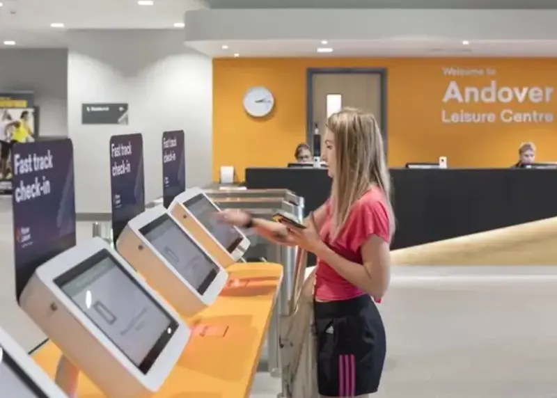 Woman using self-service terminal at Andover Leisure Centre