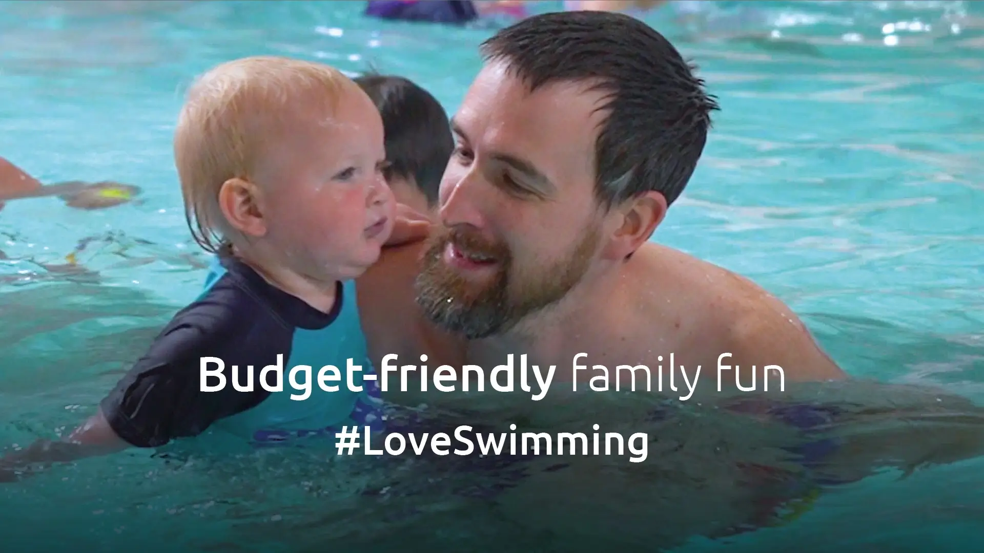 Man in swimming pool with child