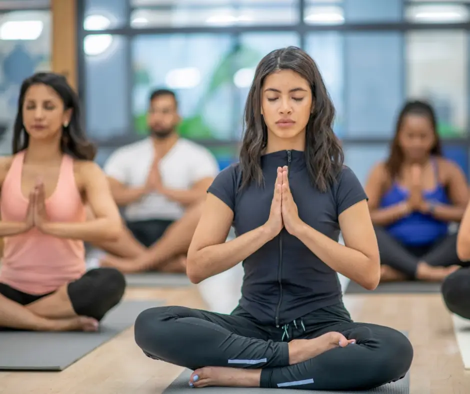 Woman meditating in group class
