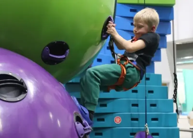 Young boy on Clip n Climb equipment