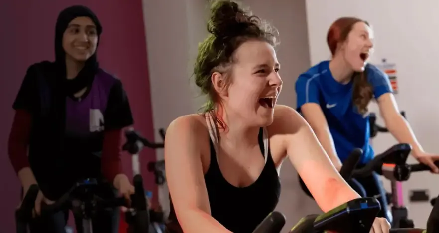 Girls taking part in group cycling class