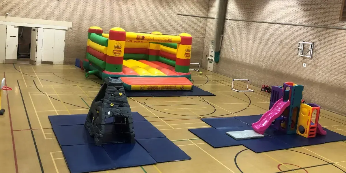 Bouncy castle and soft play equipment in sports hall