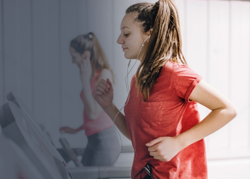 2 Column View Image Young Woman On Treadmill With Headphones