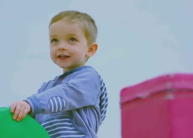 Child playing with soft play equipment