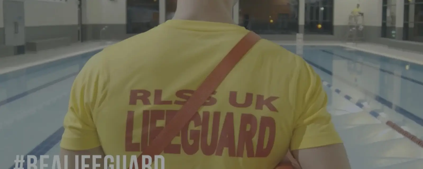 Lifeguard with RLSS UK on back of t-shirt