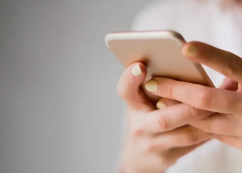 Close up on someone holding mobile phone