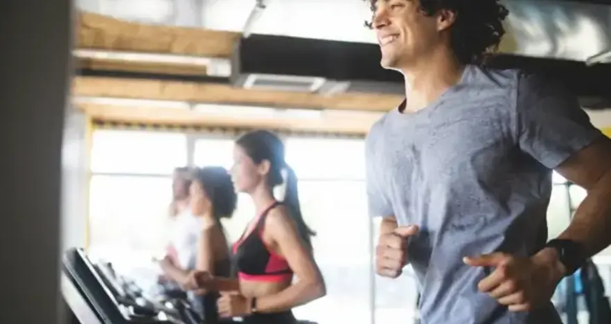 Man on treadmill with others in the background